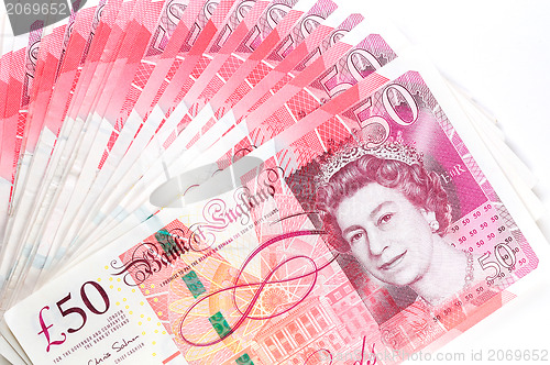 Image of 50 pound sterling bank notes closeup view business background