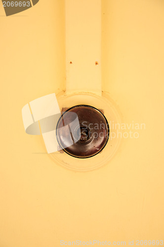 Image of Old Vintage bakelite light switch isolated against white background from low perspective.