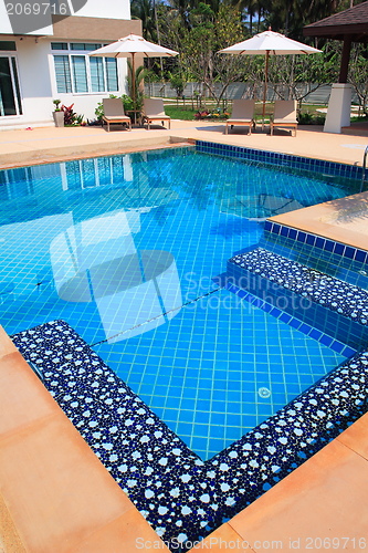 Image of Swimming pool with stair and green relaxing water 