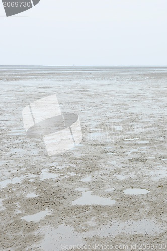 Image of Cracked earth on the sea background. 