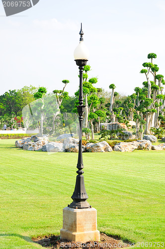 Image of Black lamppost in a summer garden 