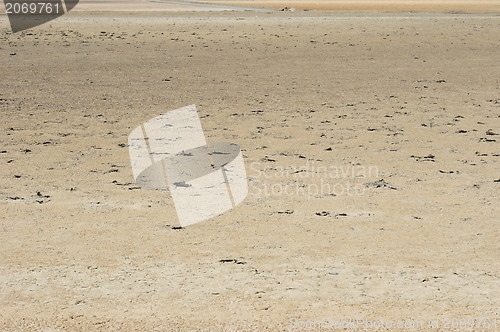 Image of Cracked earth on the sea background. 