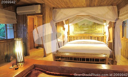 Image of Bedroom in a wood bungalow. 