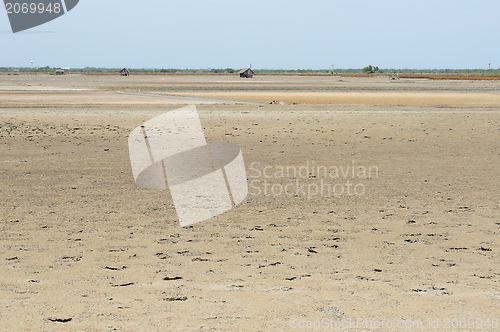 Image of Cracked earth on the sea background. 