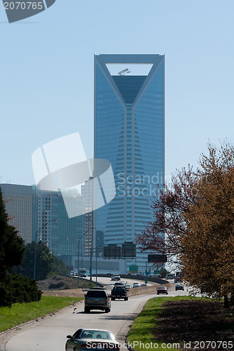 Image of highway road leads to city skyscraper