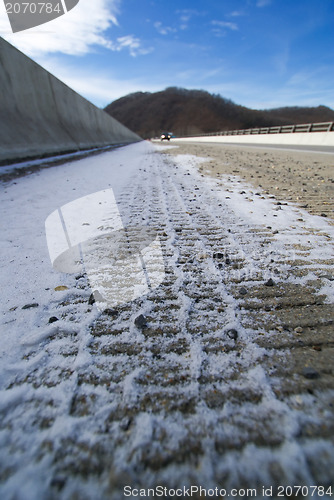 Image of tire print on the snowy road