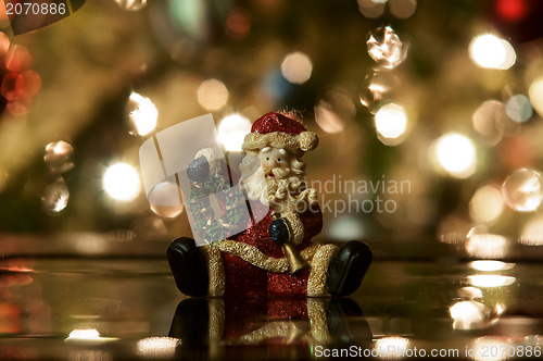 Image of Festive santa with Christmas light background