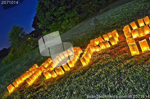 Image of Hope spelled out with candles on grass field