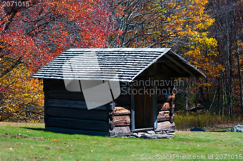 Image of log cabin in the fall