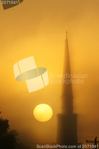 Image of steeple in fog at sunrise