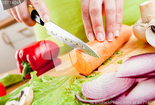 Image of Woman's hands cutting vegetables