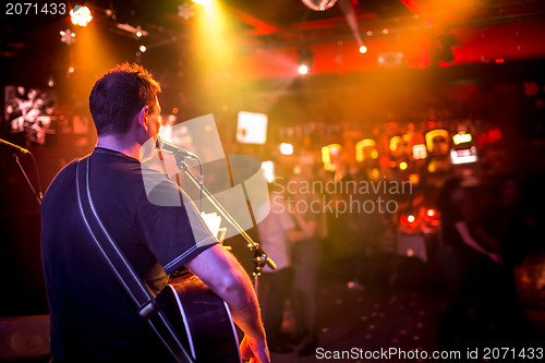 Image of musician plays a guitar