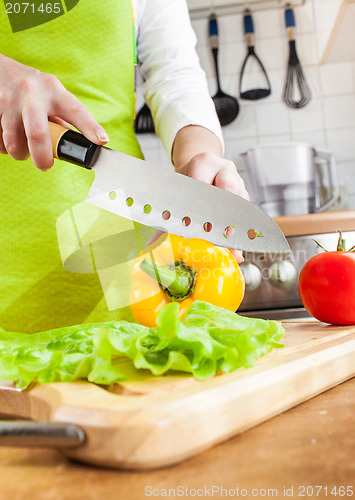 Image of Woman's hands cutting vegetables
