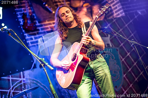 Image of musician plays a guitar