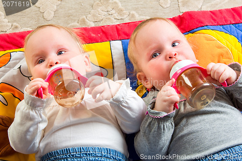 Image of babies eating from bottle