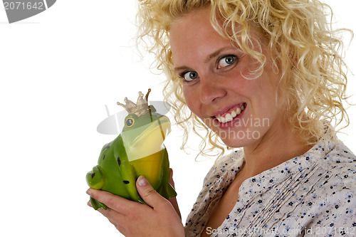 Image of Young woman kissing a frog prince