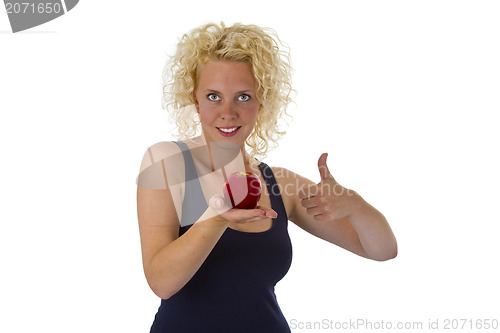 Image of Beautiful blond woman holding red apple