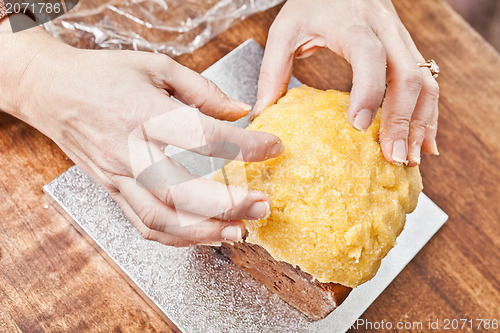 Image of Hands modeling cake icing