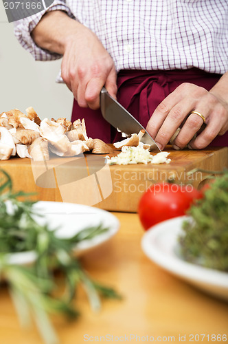 Image of Man Cutting Mushrooms On Chopping Board