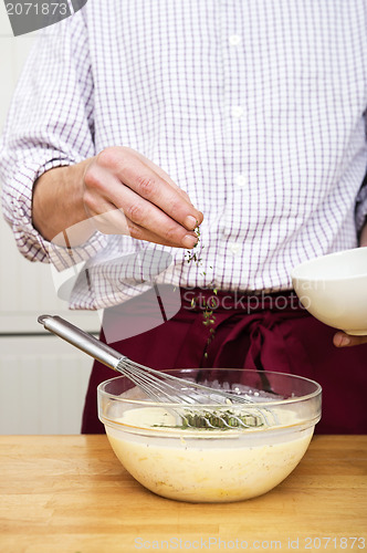 Image of Man Sprinkling Thymes In Batter