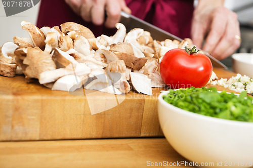Image of Midsection Of Man Cutting Mushrooms