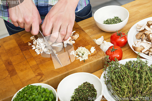 Image of Closeup Of Man Chopping Mushrooms