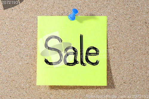 Image of The word SALE Note paper with push pins on noticeboard 