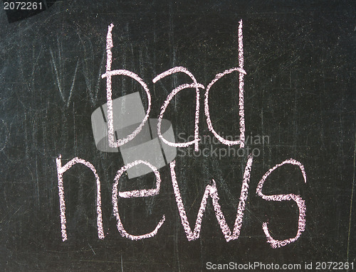 Image of  The word BAD handwritten with chalk  on a blackboard