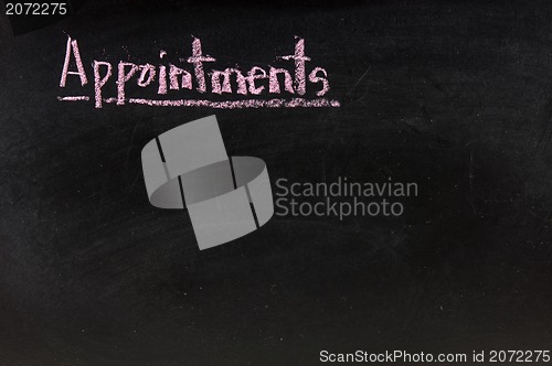 Image of  The word appointments handwritten with chalk  on a blackboard