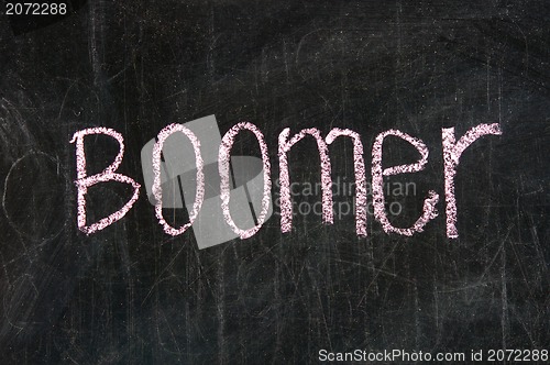 Image of The word BOOMER handwritten with chalk  on a blackboard