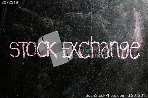 Image of business STOCK EXCHANGE written on blackboard