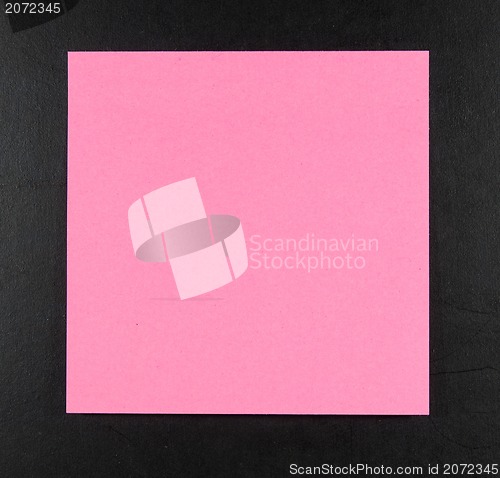 Image of pink postit on a blackboard