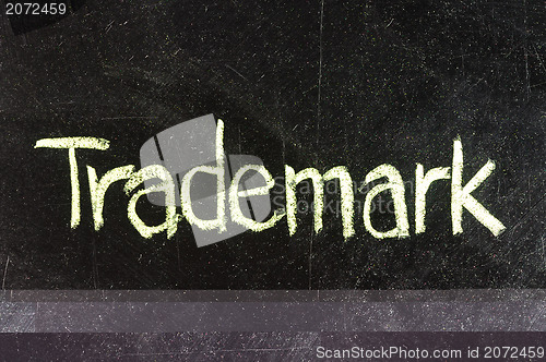 Image of TRADEMARK handwritten with white chalk on a blackboard