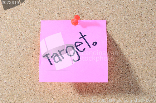 Image of The word TARGET Note paper with push pins on noticeboard 