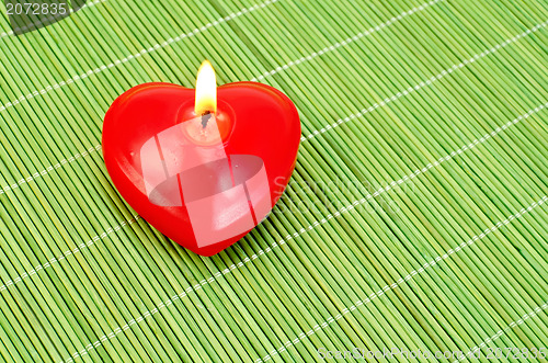 Image of Heart of candles on a green bamboo