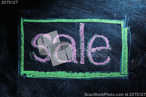 Image of Sale handwritten with white chalk on a blackboard 