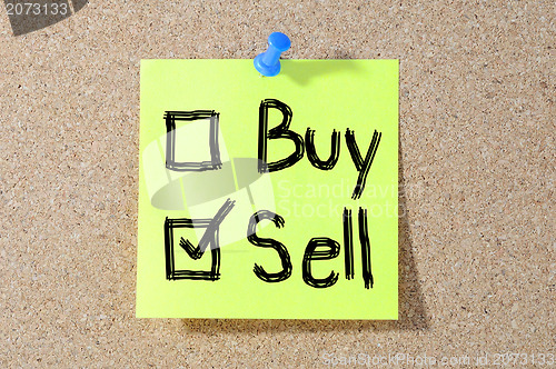 Image of Buy or sell check boxes written on a board 
