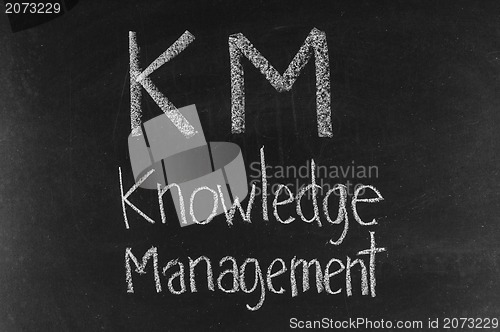 Image of KM concept written on blackboard background high resolution 