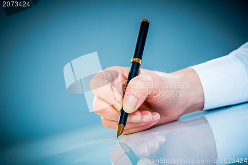 Image of Woman's hand and pen