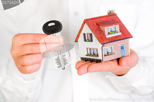 Image of house in human hands