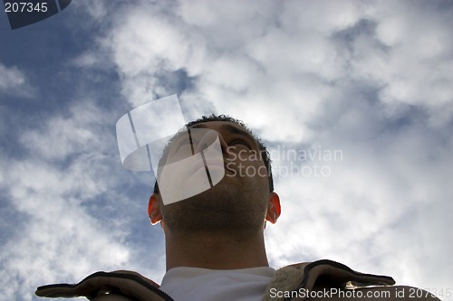 Image of Man Looking up with the Clouds on the Background