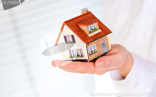 Image of house in human hands