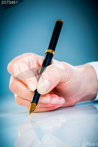 Image of Woman's hand and pen