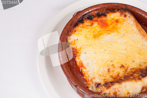 Image of Portion of lasagna in a clay pot