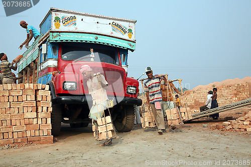 Image of Brick field workers carrying complete finish brick from the kiln