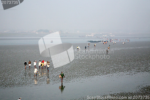 Image of During low tide the water in the river Malta falls so low that people walk to the other shore in Canning Town