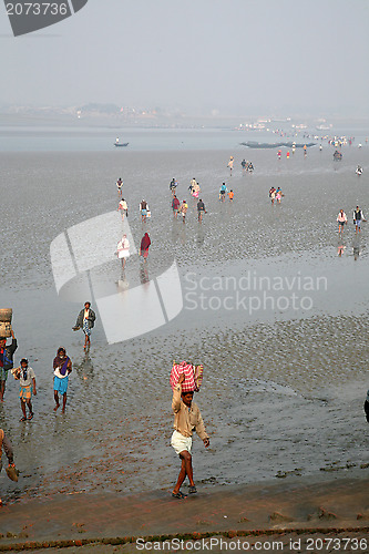 Image of During low tide the water in the river Malta falls so low that people walk to the other shore in Canning Town