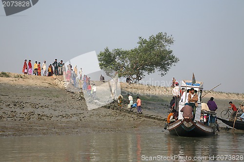 Image of Wooden boat crosses the Ganges River