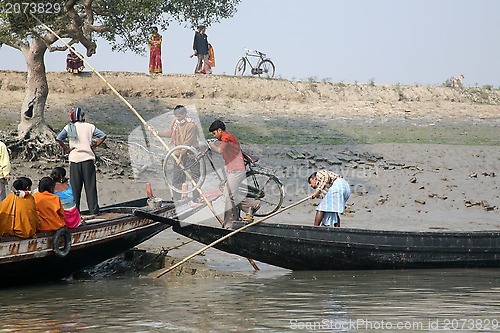 Image of Wooden boat crosses the Ganges River