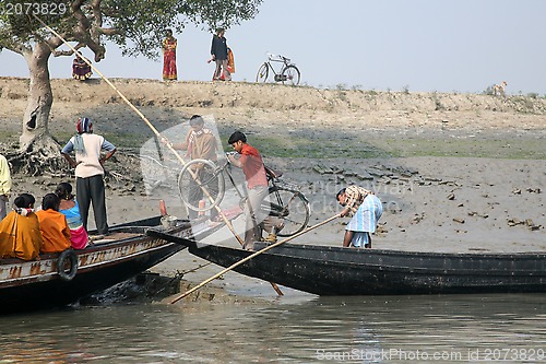 Image of Wooden boat crosses the Ganges River